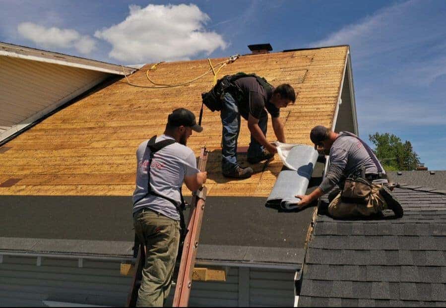 a group of men working on a roof.