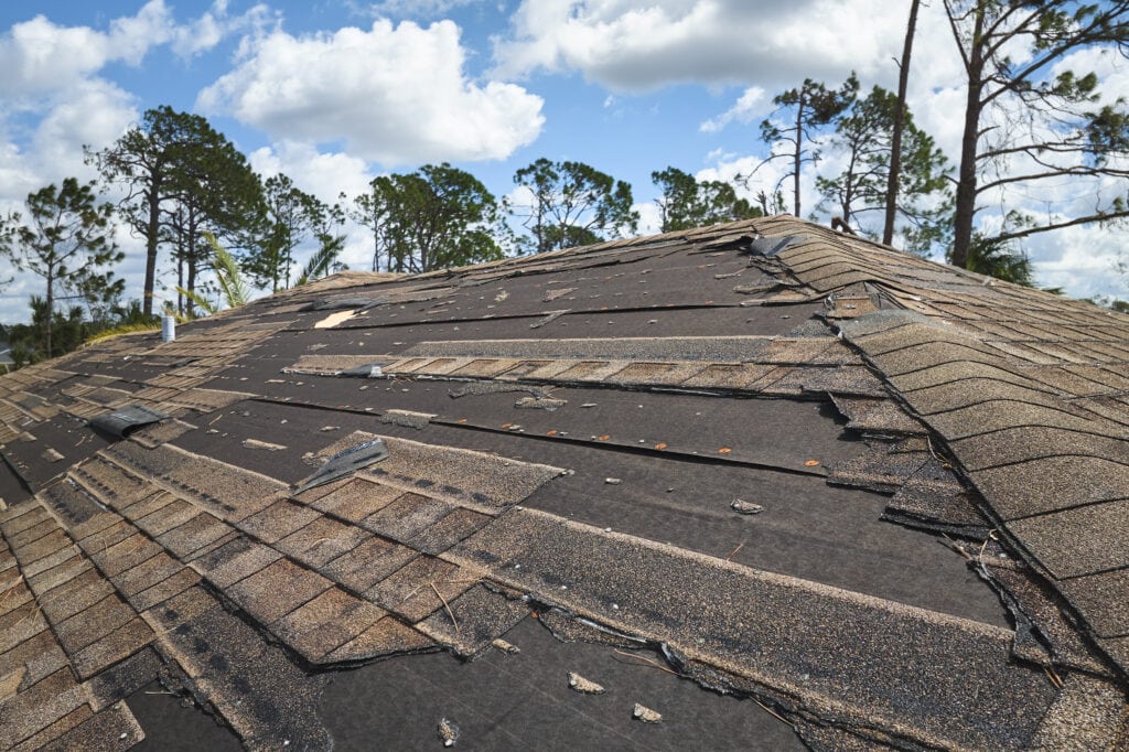 a roof with shingles that have been damaged.
