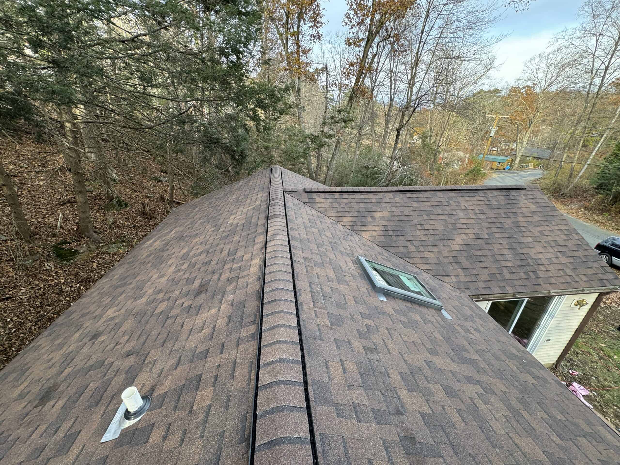 the roof of a house with a brown shingled roof.
